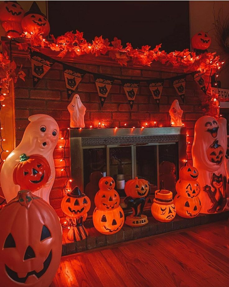 a fireplace decorated for halloween with pumpkins and ghost heads