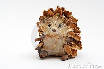 a hedgehog figurine with pine cones on it's head, sitting in front of a white background