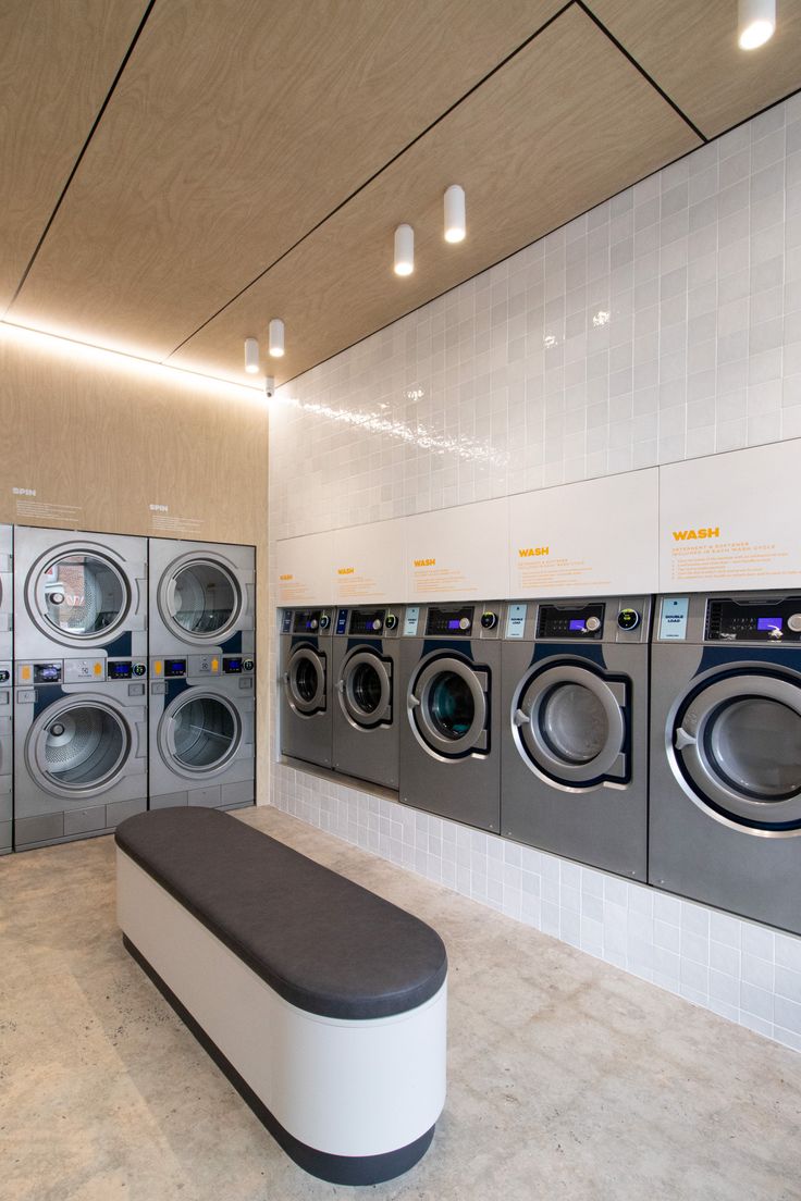 a laundry room with washers and dryers in it