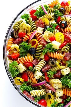 a bowl filled with pasta, meat and veggies