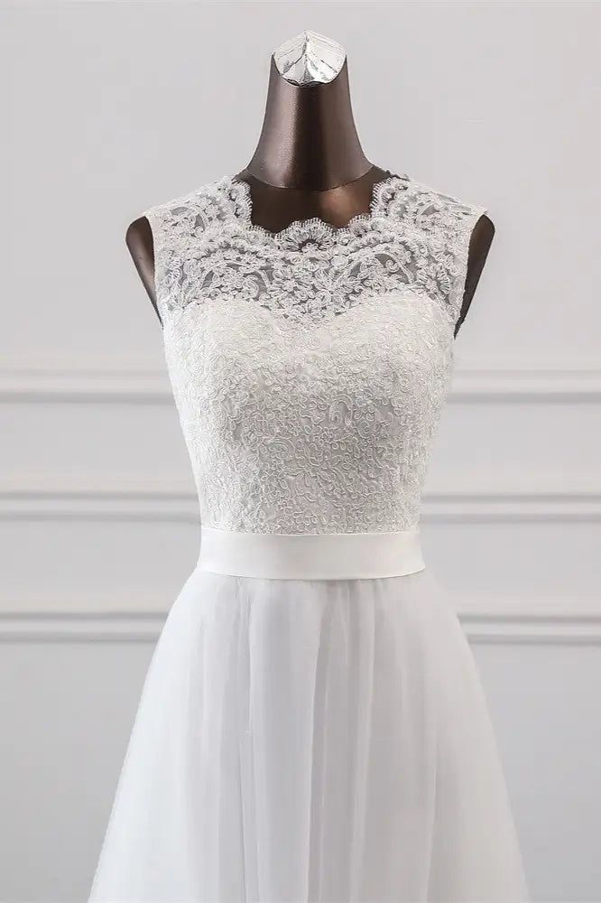 a white wedding dress on a mannequin with lace and tulle overlay