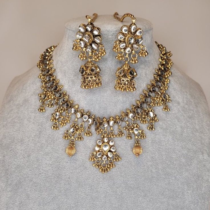 Stunning Hand Made Polki Necklace Set With Gold Beads. Necklace Is Adjustable With A Dori/Cord. And It Comes With Matching Earring With Attached Ear Chain. ~Dimensions- Necklace Length: 24 Cm, Necklace Width: 5 Cm, Necklace Weight: 1.7 Oz. Each Earring: Earring Length: 5 Cm + Era Chain, Earring Width: 2.5 Cm, Weighs: 0.40 Oz. Festive Dangling Beads Dangle Jewelry, Festive Dangle Jewelry With Dangling Beads, Festive Dangling Bead Jewelry, Gold Beads Jewelry As Gift, Gold Beads Metal Jewelry As A Gift, Metal Jewelry With Gold Beads For Gifts, Metal Jewelry With Dangling Beads For Celebration, Gold Metal Beaded Necklace For Wedding, Teardrop Silver Beads Metal Jewelry