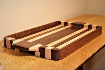 a wooden cutting board sitting on top of a table