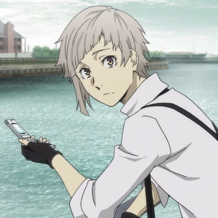 an anime character is looking at his cell phone while standing near the water with buildings in the background