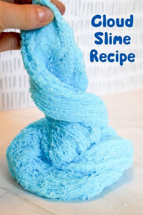 a hand holding a blue cloth with the words cloud slime recipe on it