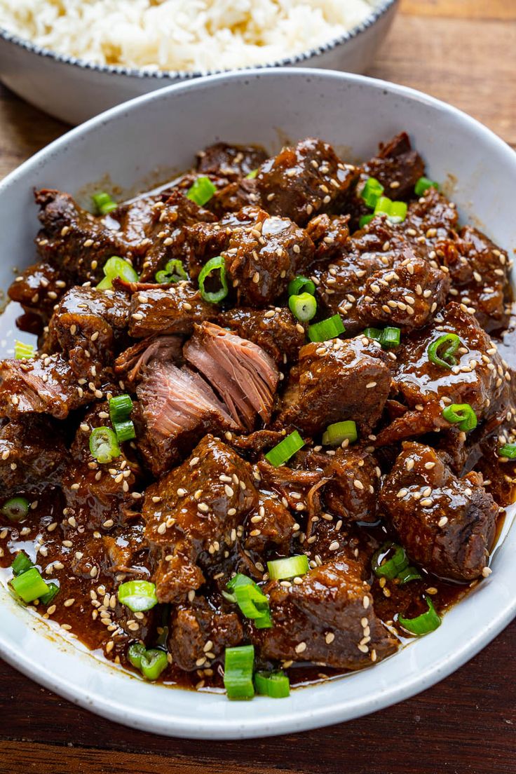 a white bowl filled with beef and rice