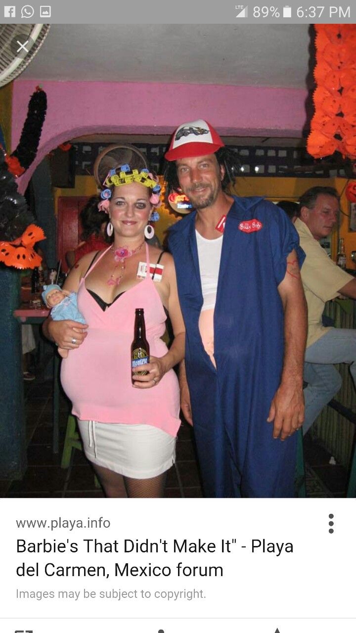 a man and woman dressed in costumes standing next to each other with beer bottles on their heads