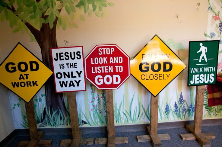 there are many different signs on the wall in this room, including jesus is the listener to god and walk with jesus