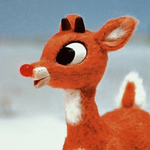 a close up of a toy deer with big eyes and nose piercings on it's head