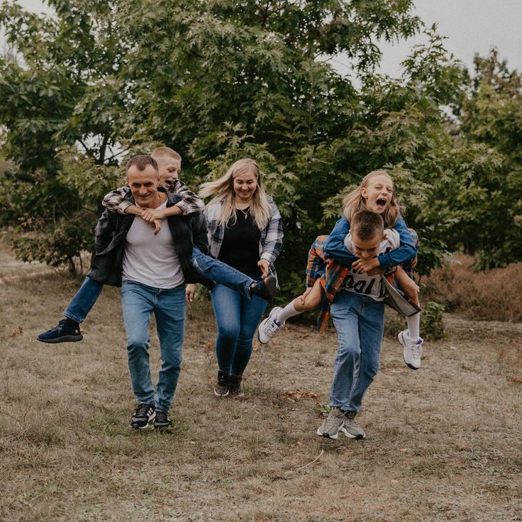 a group of people walking through a field with one person holding the other's back