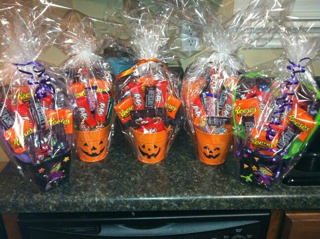 some candy wrapped in plastic bags and sitting on top of a counter next to a microwave