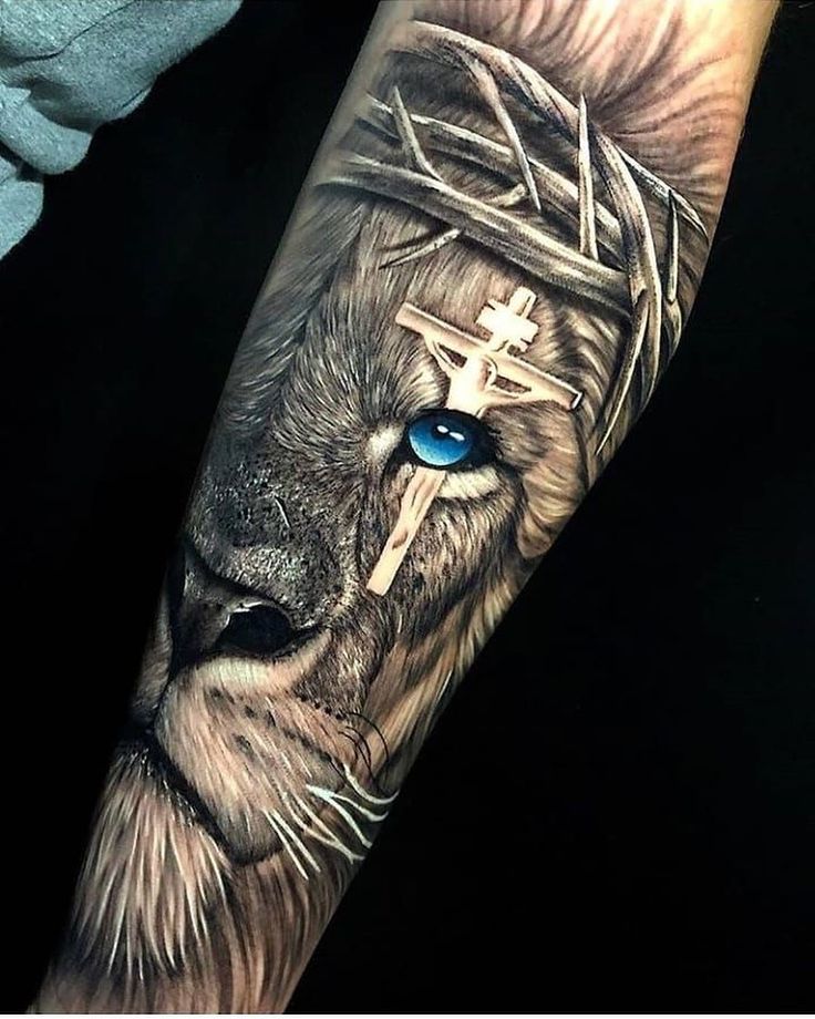 a man's arm with a lion and cross on it