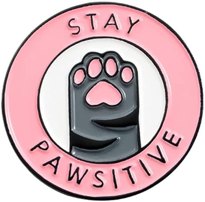 a pink and black pin with a paw on it that says stay pawstivee