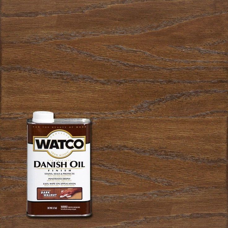 a bottle of wood stain sitting on top of a wooden table next to a can of wax