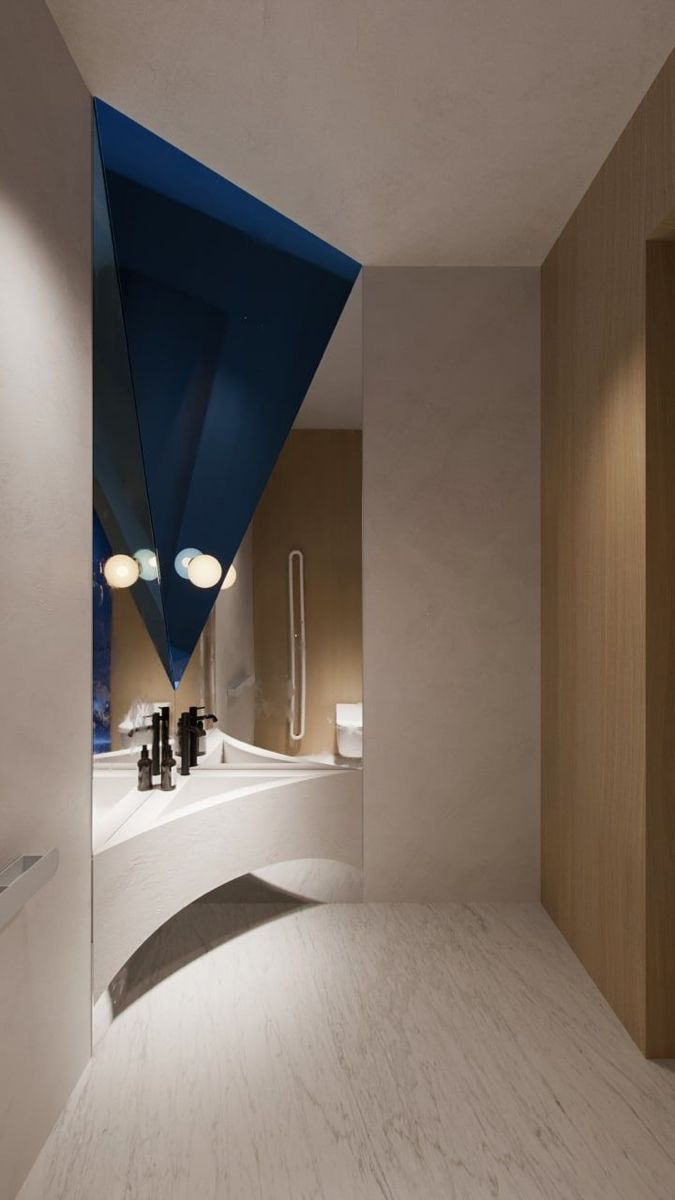 a modern bathroom with white walls and blue triangle shaped mirror over the bathtub area