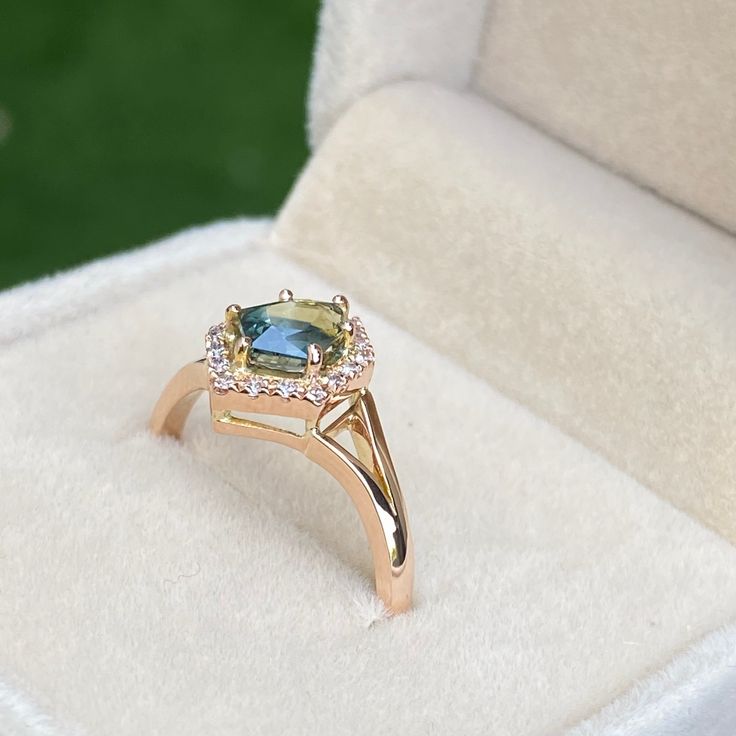 This ring features a 1.40 carat Unheated Untreated Teal Sapphire Set in 14K solid Rose Gold with natural white Diamonds . Perfect gift for Anniversary or any special occasion. Handcrafted in Sri Lanka. Comes with certificate of authenticity.Ring DetailsMain Stone: Teal SapphireCutting Style: Shield CutCarat Weight: 1.40carat.Color: TealClarity : VSCountry of Origin : MadagascarAccent Stones: Natural White Diamonds (VS/ Color G)The design can be made with gemstones of your choosing. If you would Green Engagement Rings, Peacock Sapphire, Teal Sapphire Engagement Ring, Gift For Anniversary, Teal Sapphire, Sapphire Engagement Ring, Sapphire Engagement, Engagement Rings Sapphire, White Diamonds