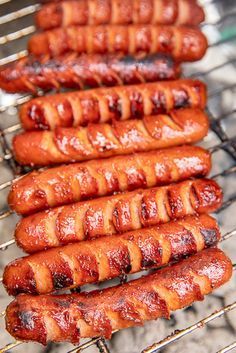 several hot dogs are being cooked on a grill