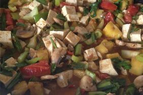 vegetables and tofu mixed together in a pan