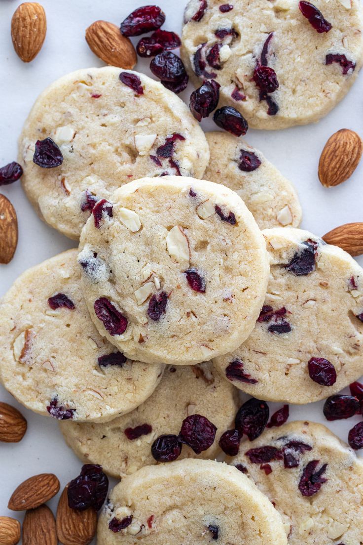 almonds and cranberry cookies on a white surface