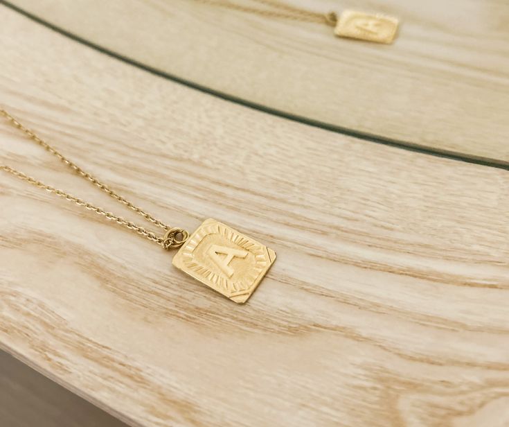 Experience the luxury of our 18k gold-plated stainless steel Initial Necklace! Free of lead and nickel, with a 16-inch chain and a 4-inch extender, you'll be stylishly adorned for any occasion. Gold Rectangular Pendant Initial Necklace With Adjustable Chain, Rectangular Gold Necklace Gift For Her, Gold Rectangular Necklaces As Gift For Her, Trendy Gold Jewelry Gift For Her, Trendy Gold Jewelry As Gift For Her, Rectangular Gold-tone Jewelry Gift, Elegant Gold-tone Nickel-free Necklaces, Gold Plated Tarnish Resistant Initial Pendant Necklace, Gold Plated Tarnish-resistant Initial Pendant Necklace