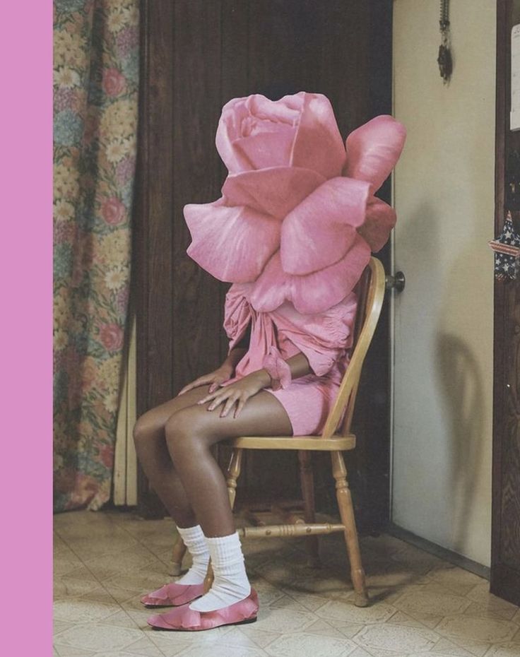 a woman is sitting in a chair with pink flowers on her head and shoes on