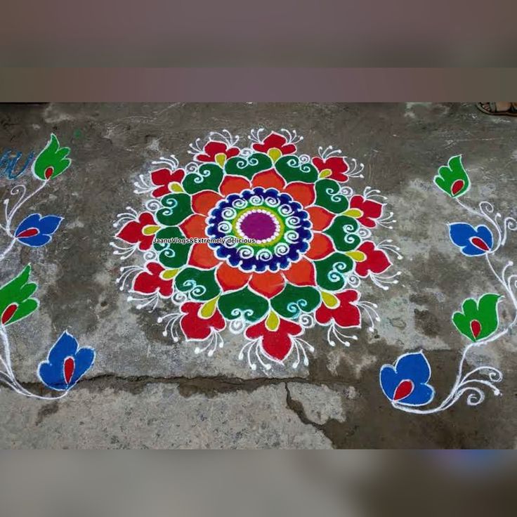 a colorful flower design painted on the ground