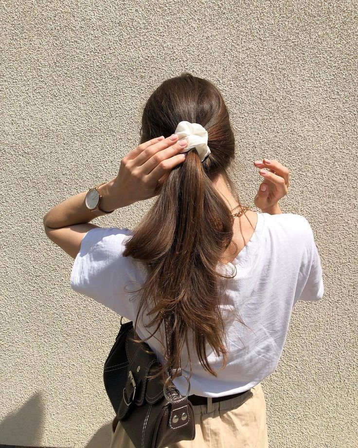 a woman with her hair in a pony tail