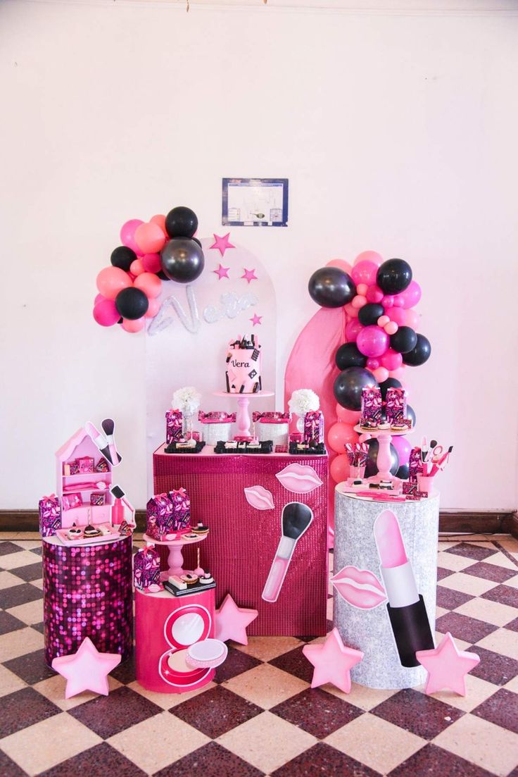 pink and black party decorations with balloons