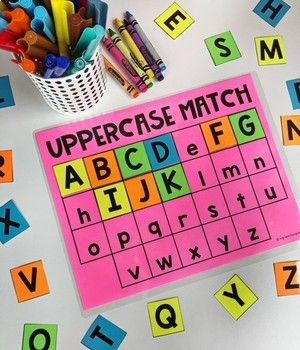 an uppercase match is displayed with crayons and markers