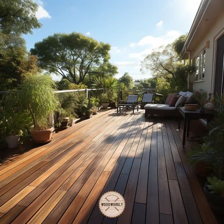 a wooden deck with chairs and plants on it