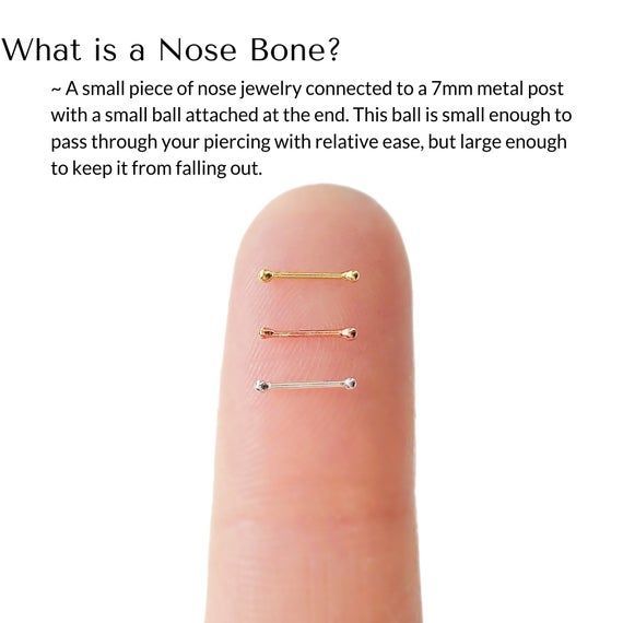 a finger with three different piercings on it and the caption what is a nose bone?