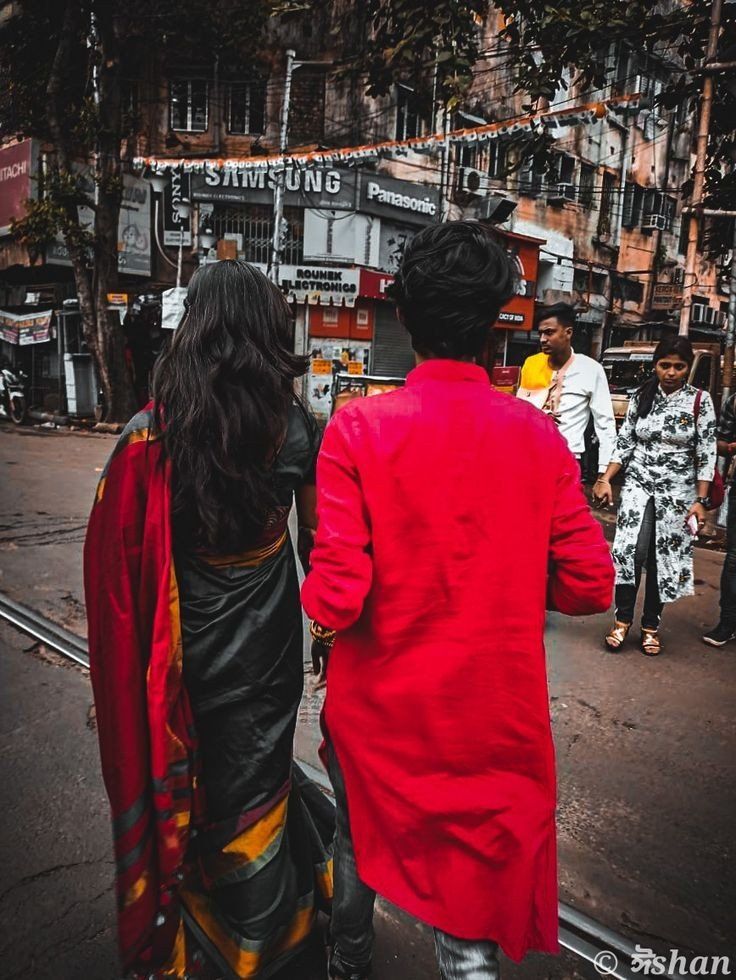 two people are walking down the street together