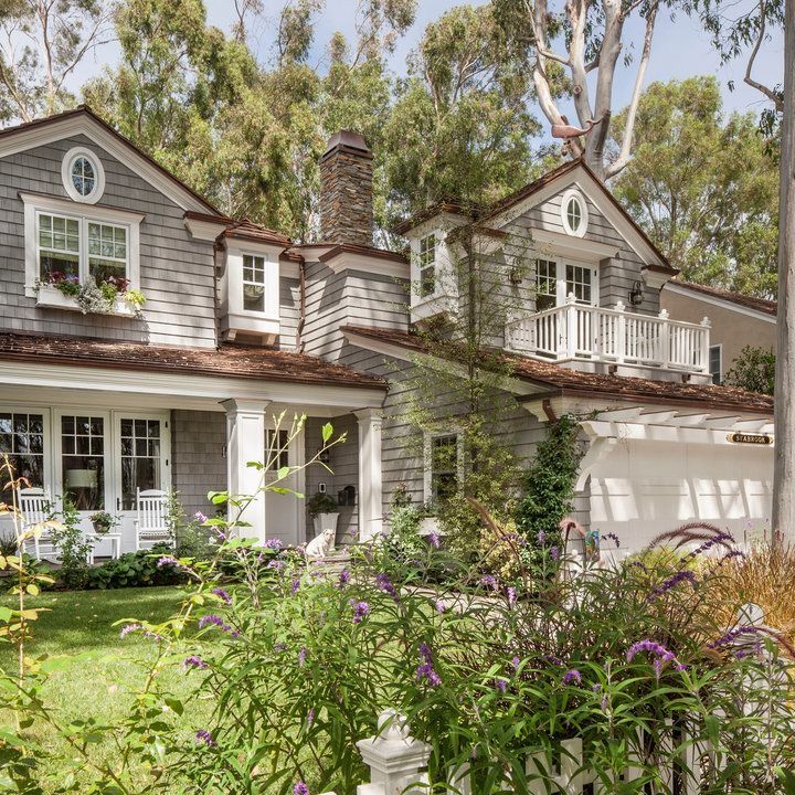 a house that has some flowers in front of it