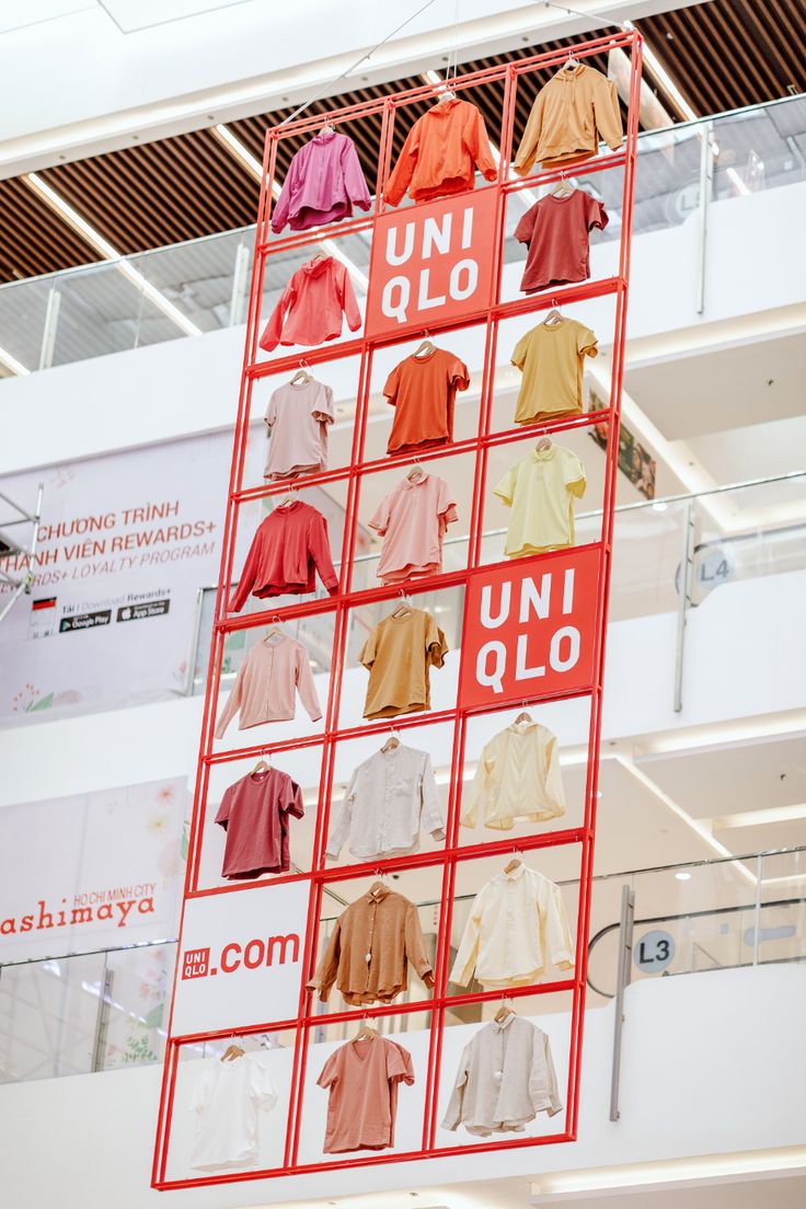 a display in a store filled with lots of different colored shirts