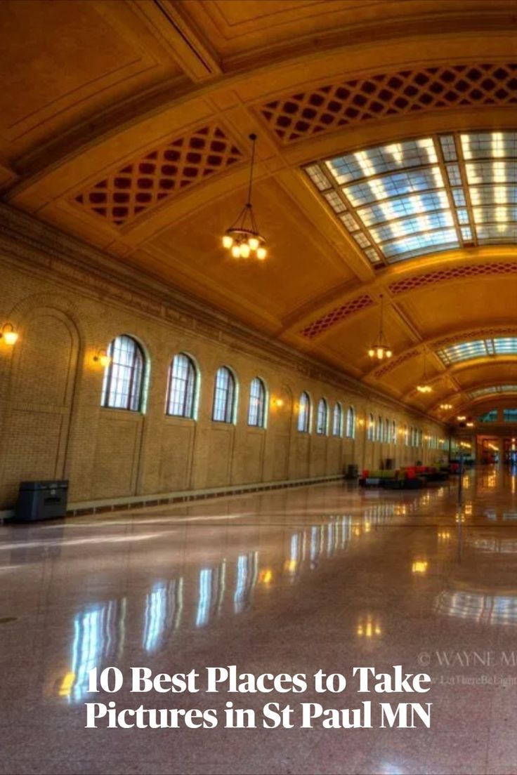 the inside of a train station with lots of windows and lights on it's ceiling