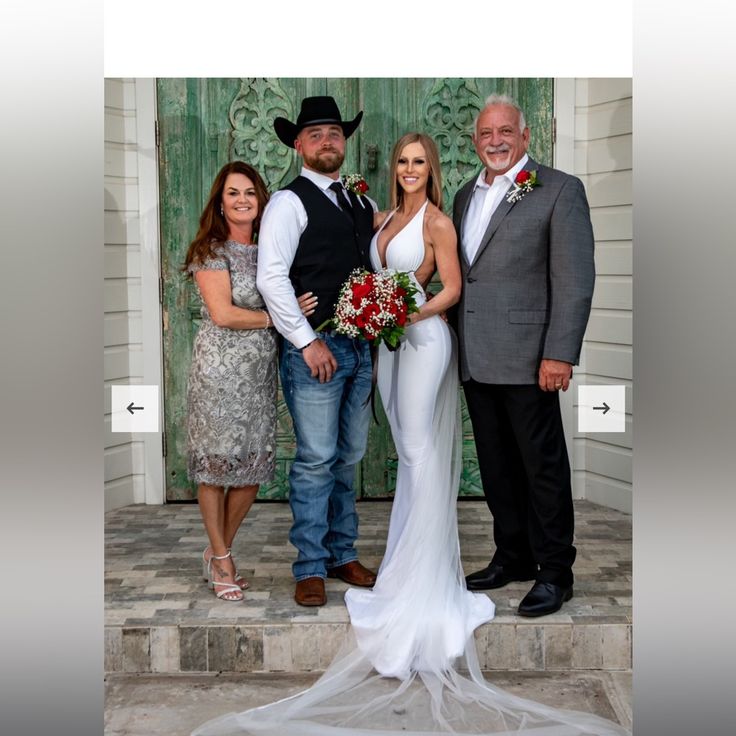 a group of people standing next to each other in front of a door with flowers