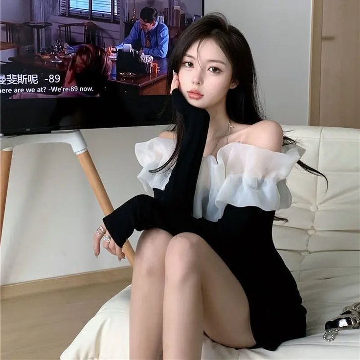 a woman sitting on a couch in front of a tv