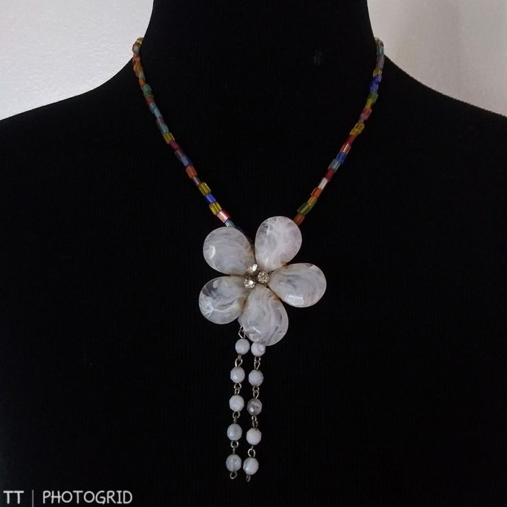 Brand New Handmade Multi Color Glass Beaded Necklace With Large Mother Of Pearl Color Flower Shaped Pendant With Drop Tassels Of Smaller Mother Of Pearl Beads And Silvertone Twist Clasp Approximate Measurements Are Taken With The Item Laying Flat And Are To Be Used As A Guide Only Please Let Me Know You Have Any Other Questions All Items In New Or Gently Used Condition Unless Otherwise Noted Offers Welcome Bundle And Save White Bohemian Flower Necklace With Round Beads, White Flower-shaped Beaded Necklace, White Beaded Flower Pendant Necklace, White Adjustable Flower Pendant Necklace, White Bohemian Necklace With Flower Pendant, White Flower Necklace With Colorful Beads, White Flower Charm Necklace For The Beach, White Necklace With Flower Charm For Party, White Flower Charm Necklace For Beach