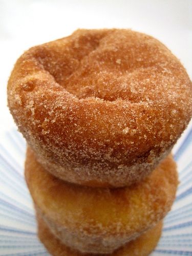 three sugared donuts stacked on top of each other