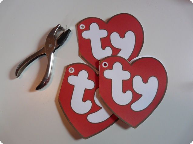 two red heart shaped cut outs with scissors