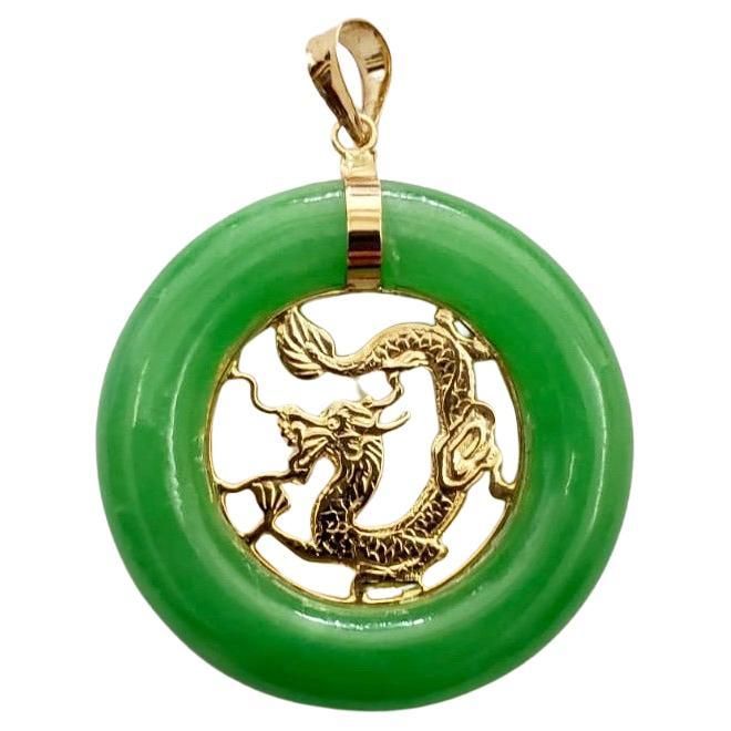 The 'Lantau Jade Dragon Donut Pendant' is an eternal tribute to Lantau Island. Rustic, natural, created, and perfect. The Jade circumference directs light to the Gold Dragon Carving, shining light onto the intricacies of design. Centrally focused, this piece of delicate design pleases even the most discerning eyes. Made out of Green Jadeite, with a solid 14K Yellow Gold accents, we accentuate the optics of the jade and contrast the hues with Gold. A classic combination of Brilliant craftsmanship and natural beauty of jade, our pieces are 100% Handmade in Hong Kong. Materials: 0.55g 14K Gold, 4.63g Jadeite Dimensions: 25 x 25 x 5 mm Gross Weight: 5.18 g (Gold Chain not included) Dragon Carving, Lantau Island, Dragon Green, Donut Pendant, Jade Dragon, Shining Light, Gold Dragon, Dragon Pendant, Delicate Design