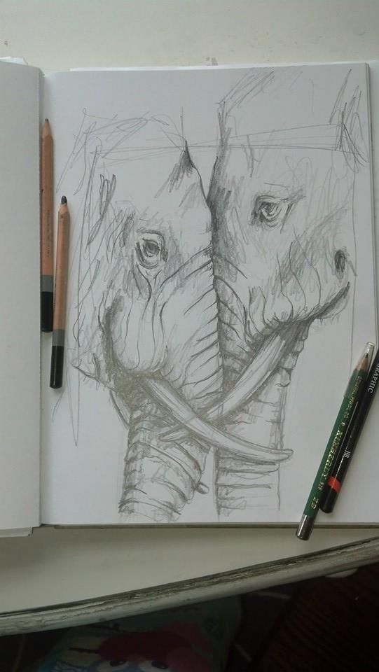 an open notebook with a drawing of two elephants