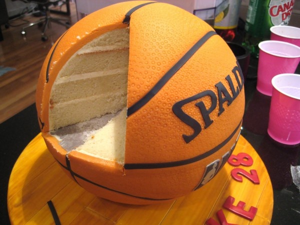 this cake is made to look like a basketball ball and has been cut in half