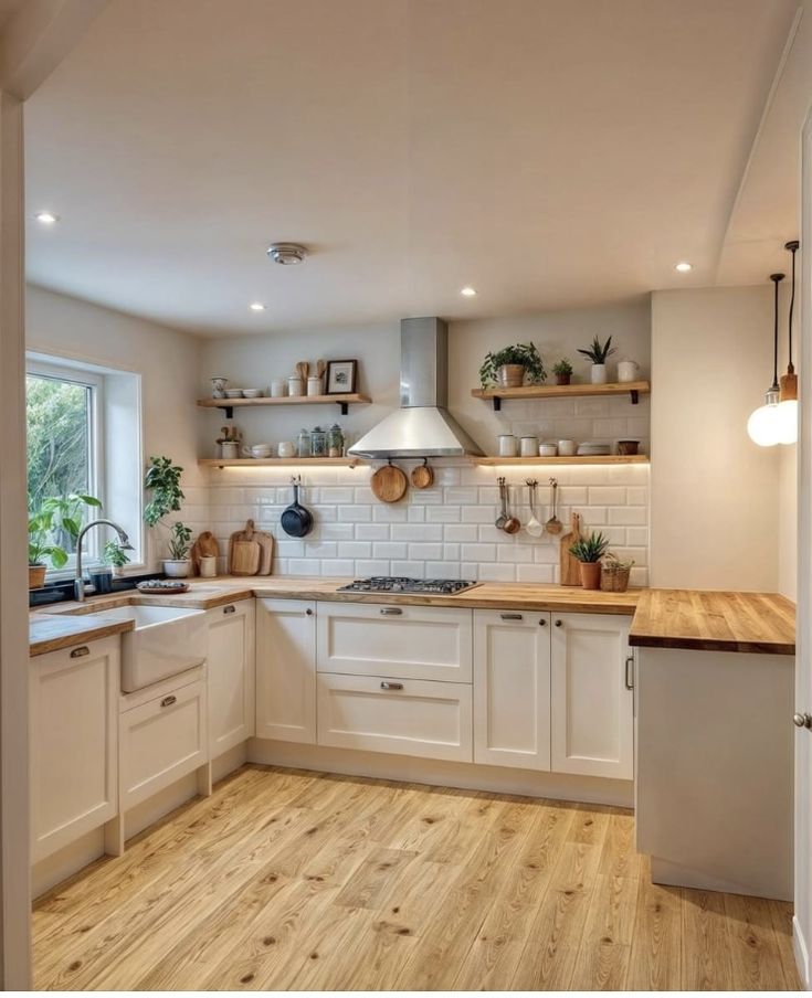 a kitchen with wooden floors and white cabinets