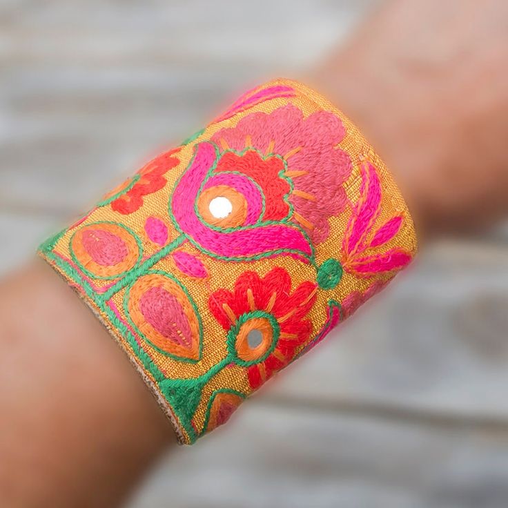 a woman's arm with a colorful bracelet on it and a light in the middle