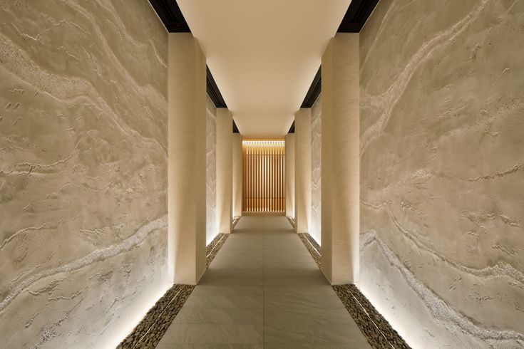 a long hallway with white walls and columns