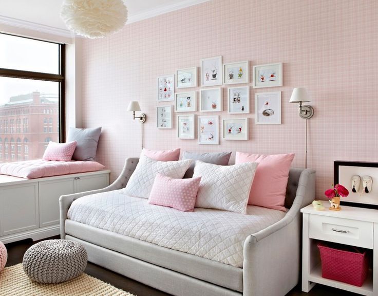 a bedroom with pink walls and white furniture