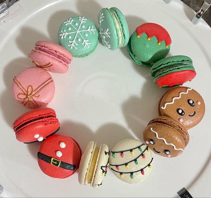 a white plate topped with macaroons and donuts covered in frosted icing