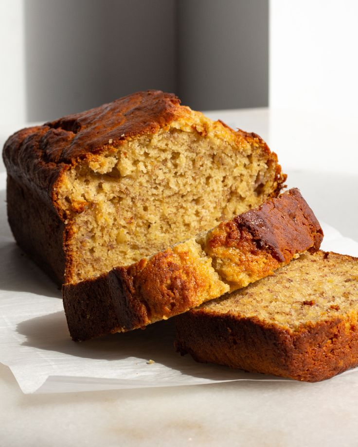 two slices of banana bread sitting on top of white paper