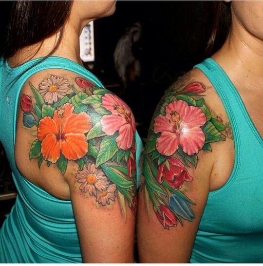 two women with tattoos on their arms and shoulder, both have flowers painted on them